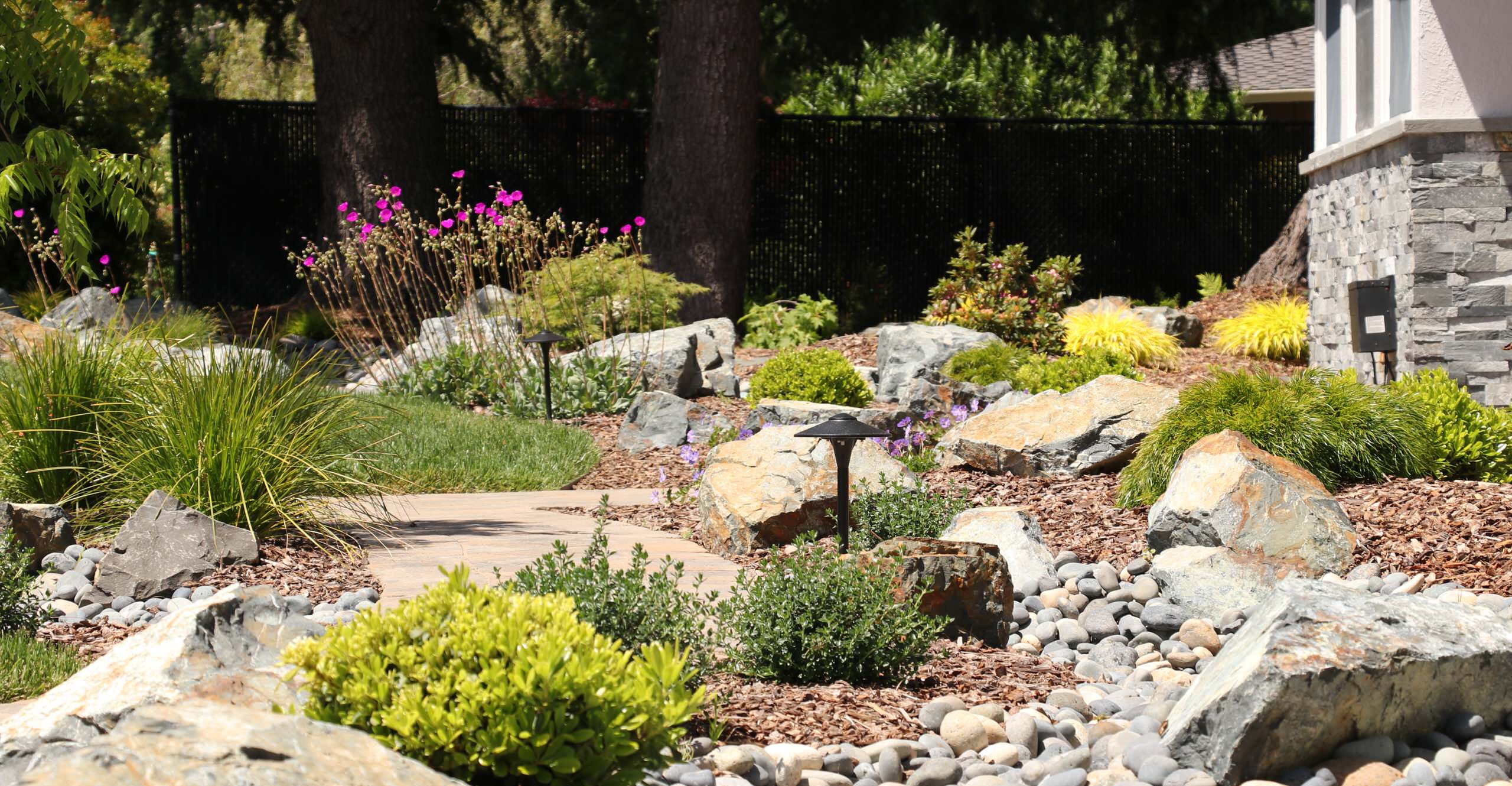 FRONT YARD WITH TREES AND DRY-CREEK