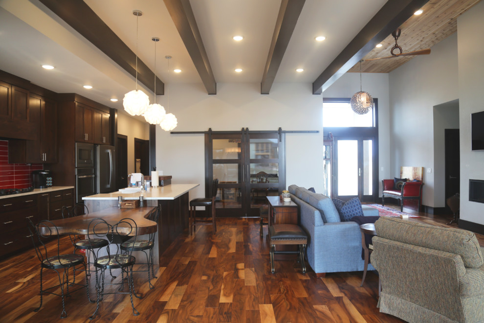 Inspiration for a mid-sized transitional galley medium tone wood floor eat-in kitchen remodel with a double-bowl sink, recessed-panel cabinets, dark wood cabinets, granite countertops, red backsplash, porcelain backsplash, stainless steel appliances and an island