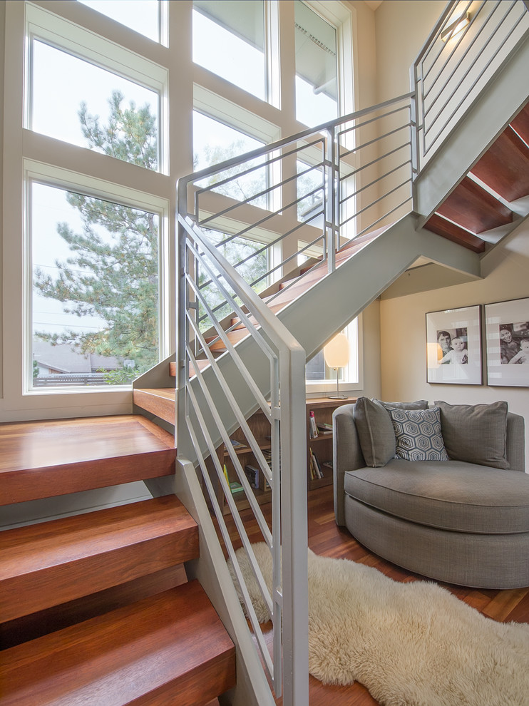Photo of a mid-sized contemporary wood u-shaped staircase in Denver with open risers.