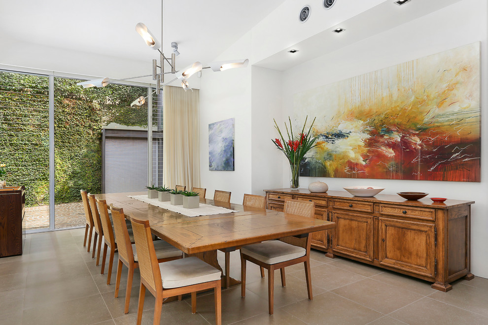 Inspiration for an expansive contemporary dining room in Sydney with white walls and limestone floors.