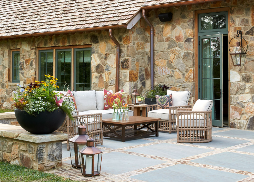 Inspiration for a farmhouse backyard concrete paver patio remodel in Birmingham with a fire pit and no cover
