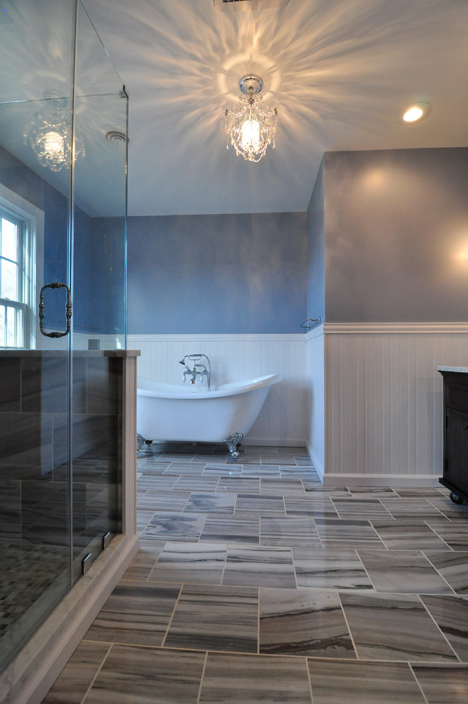 Photo of a large transitional master bathroom in Philadelphia with an undermount sink, furniture-like cabinets, grey cabinets, marble benchtops, a claw-foot tub, a corner shower, a two-piece toilet, multi-coloured tile, stone slab, marble floors and blue walls.