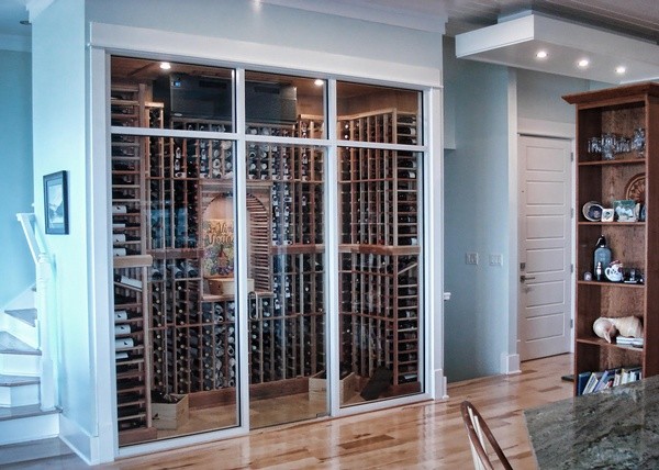 This is an example of a large beach style wine cellar in Tampa with medium hardwood floors and beige floor.