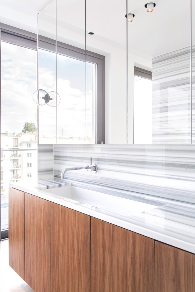 This is an example of a large contemporary master bathroom in Berlin with flat-panel cabinets, brown cabinets, white walls and an integrated sink.