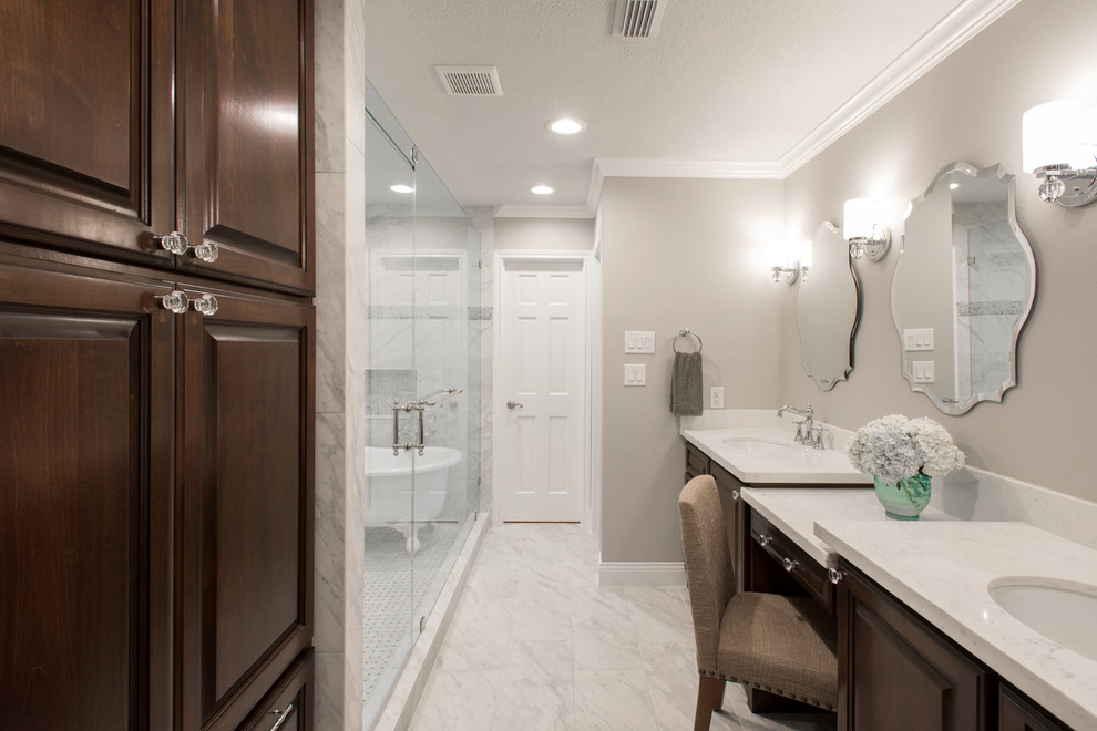 Mid-sized country master bathroom in Houston with an undermount sink, raised-panel cabinets, dark wood cabinets, marble benchtops, a freestanding tub, an open shower, a one-piece toilet, white tile, stone tile, grey walls and marble floors.
