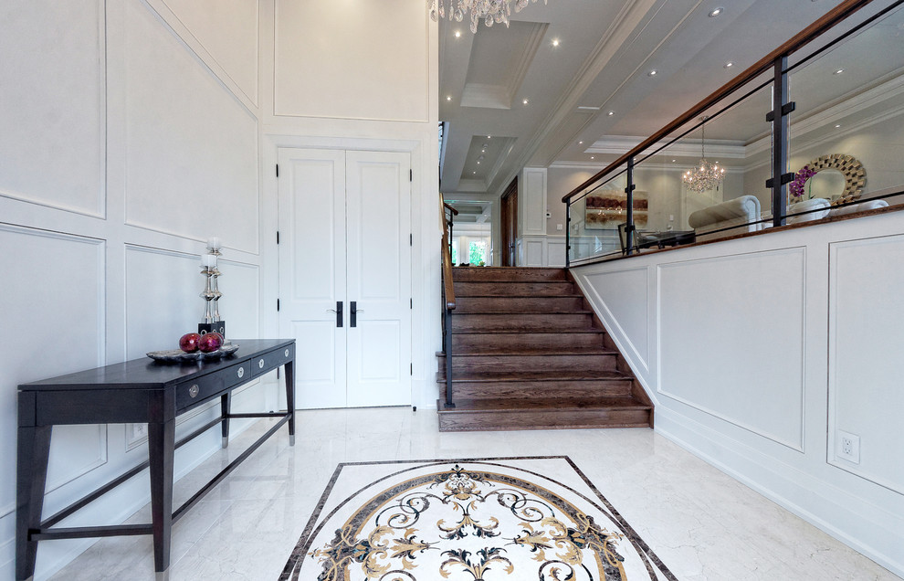 Example of a large transitional granite floor front door design in Toronto with a dark wood front door and white walls