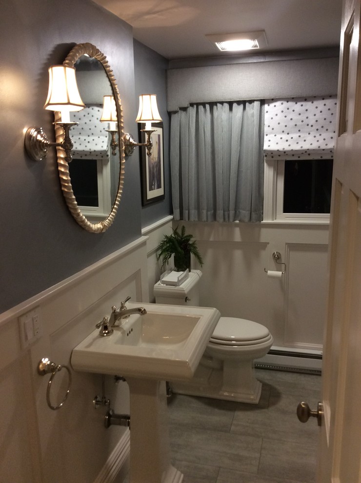 Inspiration for a mid-sized transitional powder room in Miami with a two-piece toilet, grey walls, porcelain floors, a pedestal sink and grey floor.