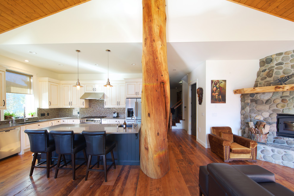 Example of a mid-sized mountain style galley medium tone wood floor open concept kitchen design in Vancouver with an undermount sink, louvered cabinets, white cabinets, multicolored backsplash, ceramic backsplash, stainless steel appliances and an island