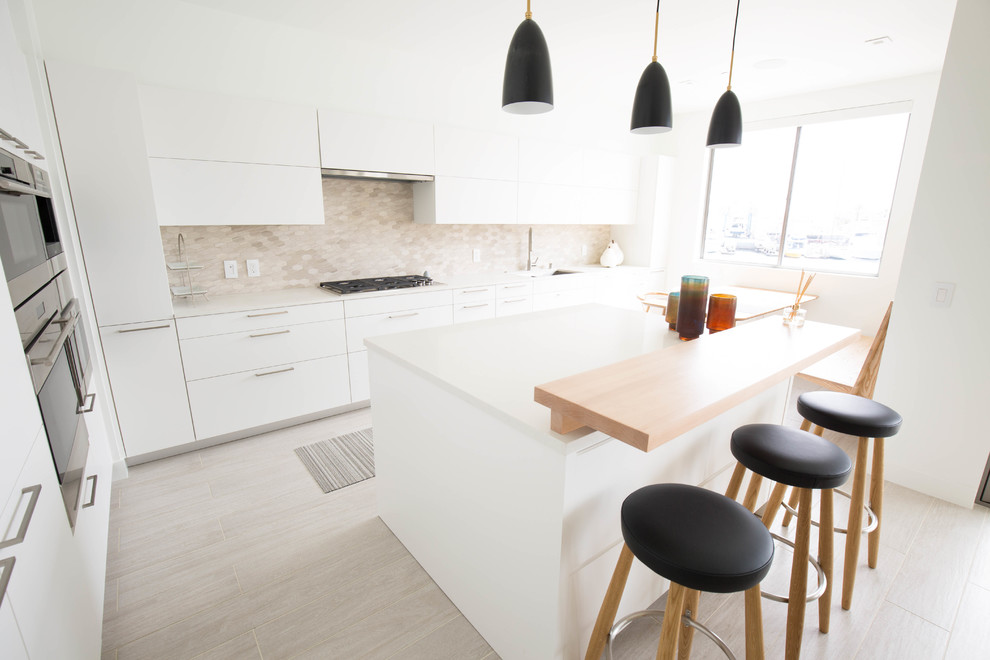 Small contemporary l-shaped eat-in kitchen in Orange County with an undermount sink, flat-panel cabinets, white cabinets, quartz benchtops, grey splashback, marble splashback, stainless steel appliances, porcelain floors, with island, grey floor and yellow benchtop.
