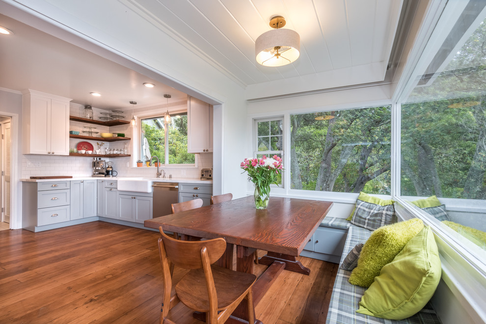 Photo of a mid-sized country kitchen/dining combo in San Francisco with white walls and medium hardwood floors.