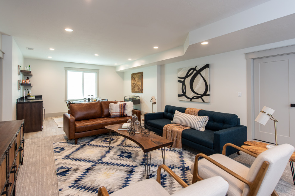 Photo of a mid-sized arts and crafts enclosed family room in Salt Lake City with white walls, carpet, no fireplace, a wall-mounted tv, beige floor and a home bar.