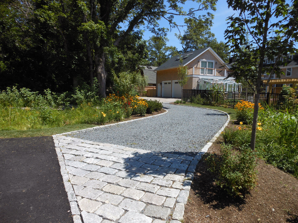 Photo of a large traditional backyard partial sun driveway for summer in Providence with gravel.
