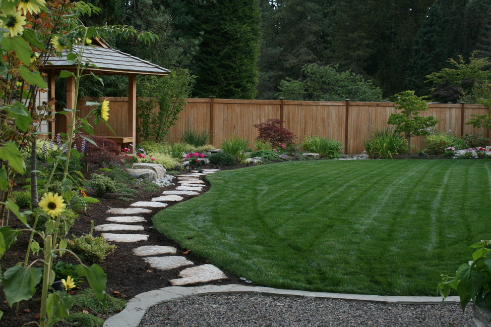 Photo of a mid-sized asian backyard partial sun garden for summer in Seattle with a water feature.