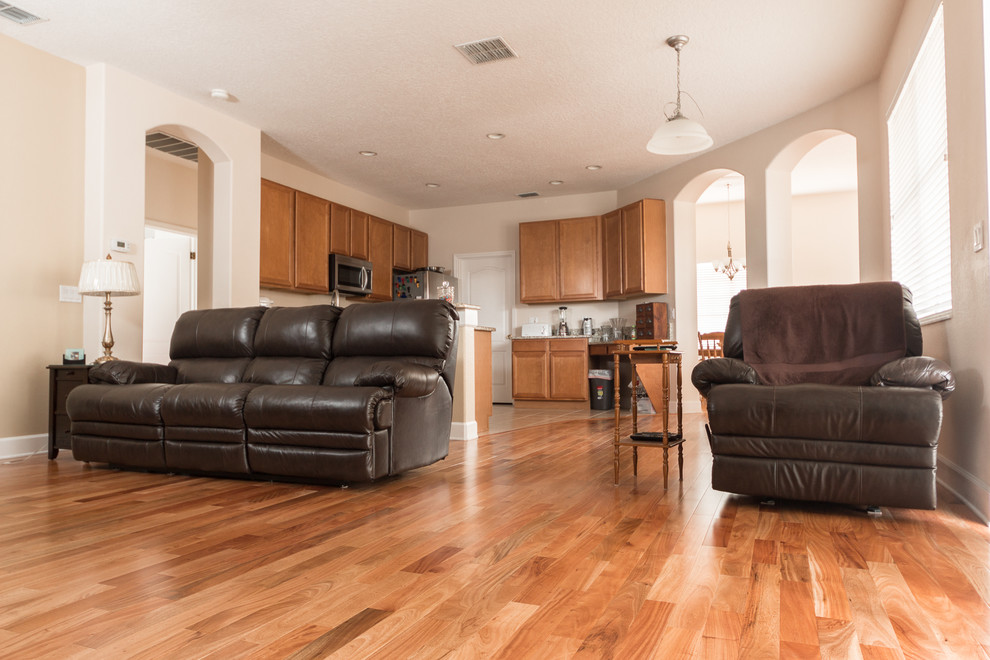 Mid-sized traditional enclosed family room in Orlando with light hardwood floors, no fireplace and a freestanding tv.