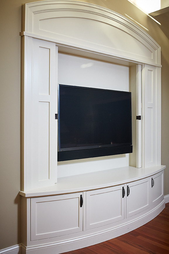 Inspiration for a traditional family room in Grand Rapids with a concealed tv.