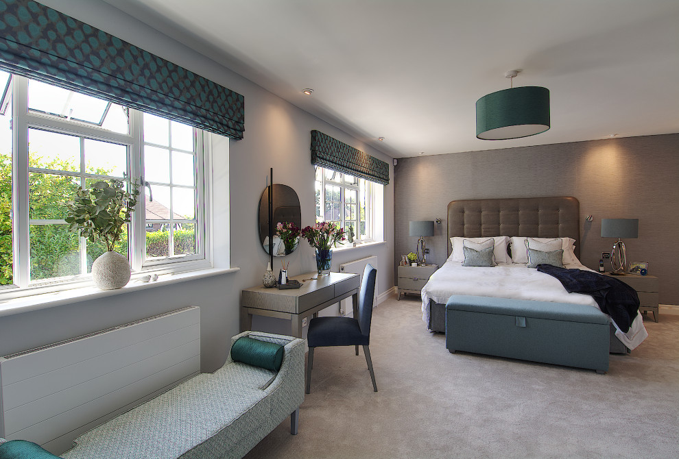 This is an example of a large contemporary master bedroom in Hampshire with blue walls, carpet, grey floor and wallpaper.