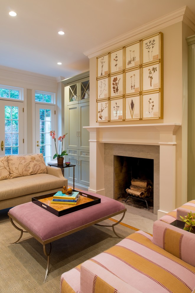 Example of a classic living room design in DC Metro with beige walls and a standard fireplace