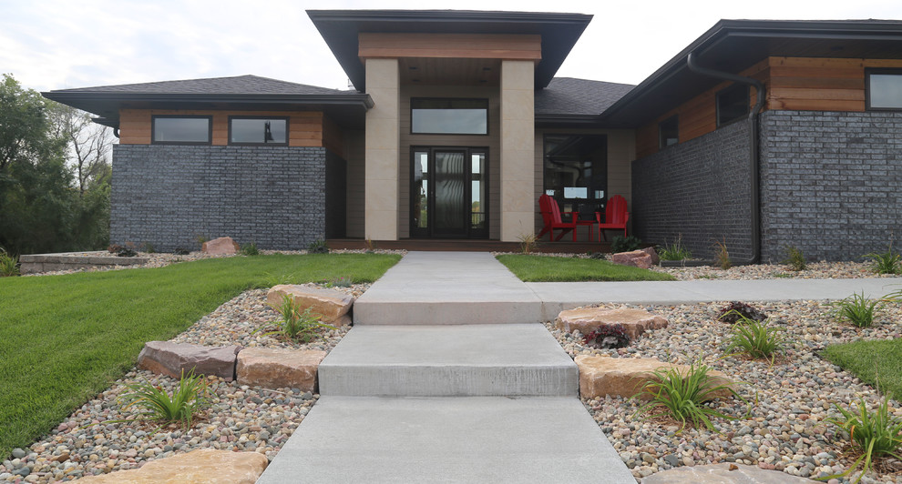 Home design - large transitional two-story brick gray home design idea with a hip roof