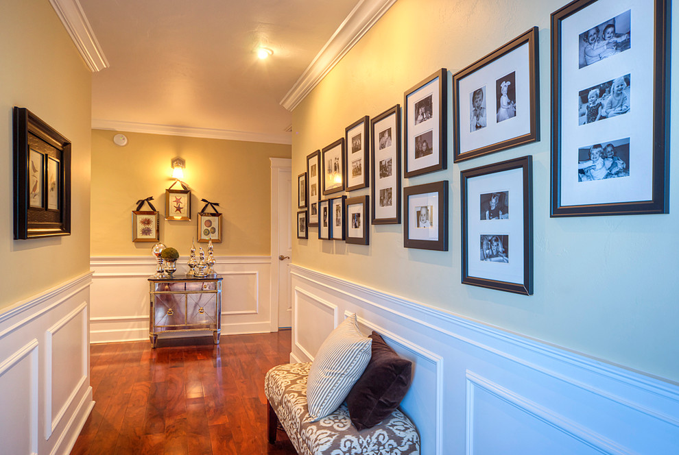 Photo of a mid-sized traditional hallway in Phoenix with beige walls, medium hardwood floors and brown floor.