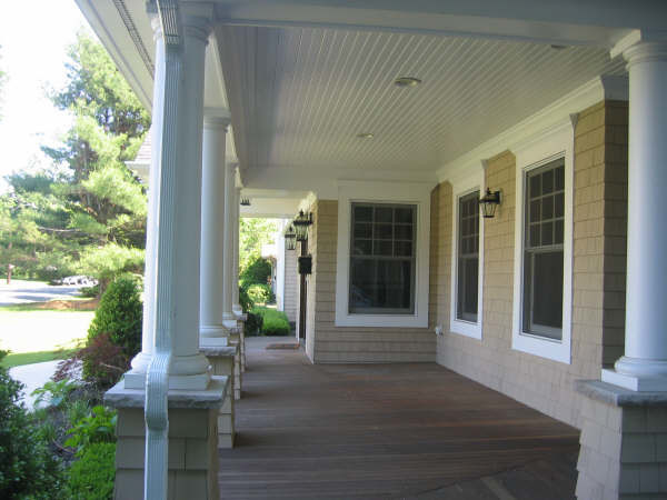 Photo of a mid-sized country front yard verandah in New York.
