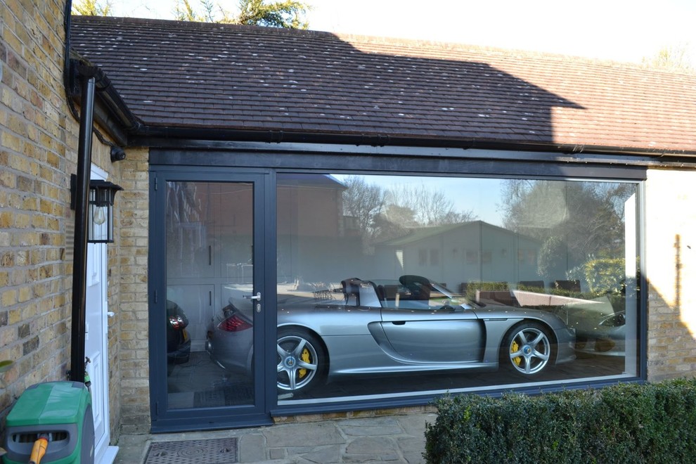 Photo of a large contemporary attached four-car carport in Hertfordshire.