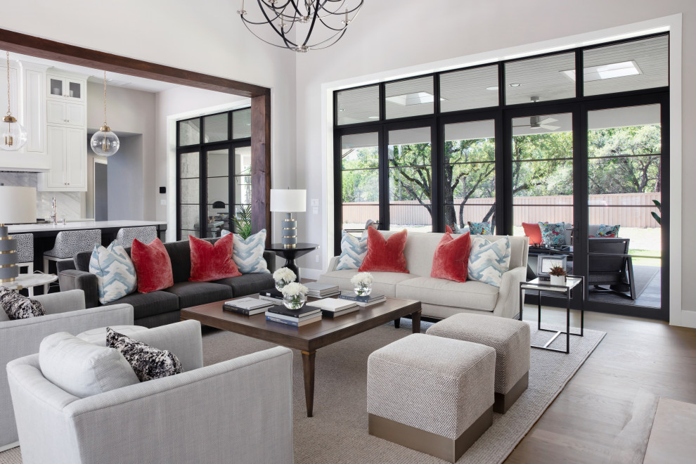 Transitional open concept living room in Austin with grey walls, medium hardwood floors and brown floor.