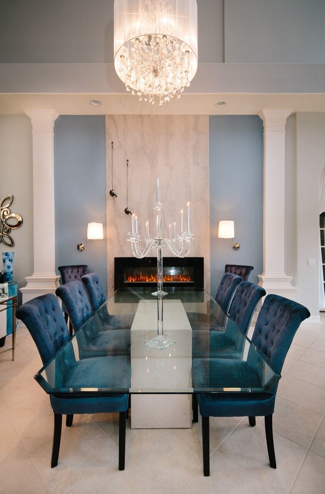 Enclosed dining room - large transitional travertine floor and beige floor enclosed dining room idea in Miami with white walls, a ribbon fireplace and a stone fireplace