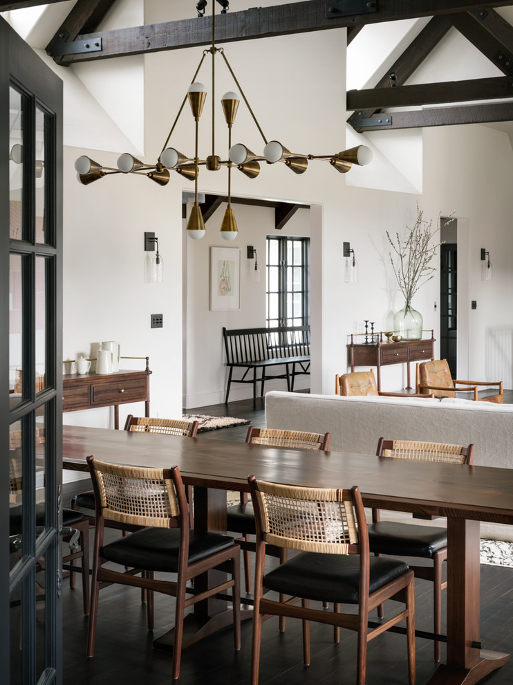 This is an example of a mediterranean dining room in Portland with white walls, dark hardwood floors and brown floor.