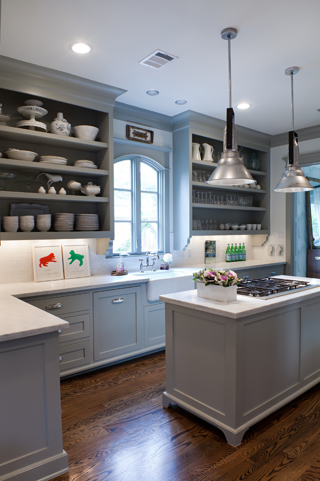 This is an example of a transitional kitchen in Houston with a farmhouse sink, open cabinets, blue cabinets, white splashback and subway tile splashback.