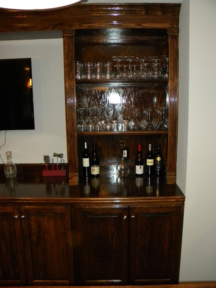 Photo of a country home bar in Philadelphia with dark hardwood floors.