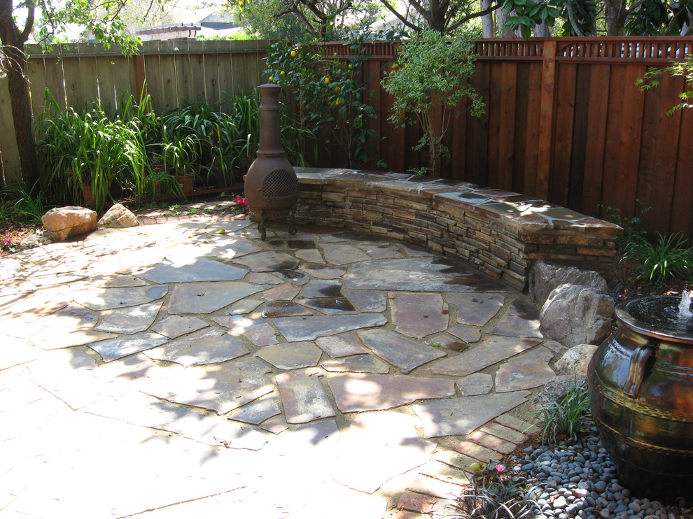 Photo of a small mediterranean front yard partial sun garden in San Francisco with a water feature and natural stone pavers.
