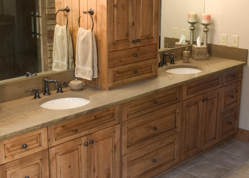 Photo of a traditional bathroom in Oklahoma City with white cabinets and solid surface benchtops.
