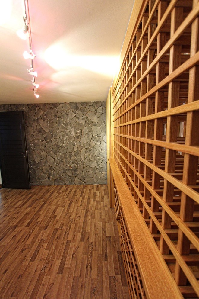 This is an example of a large beach style wine cellar in Paris.