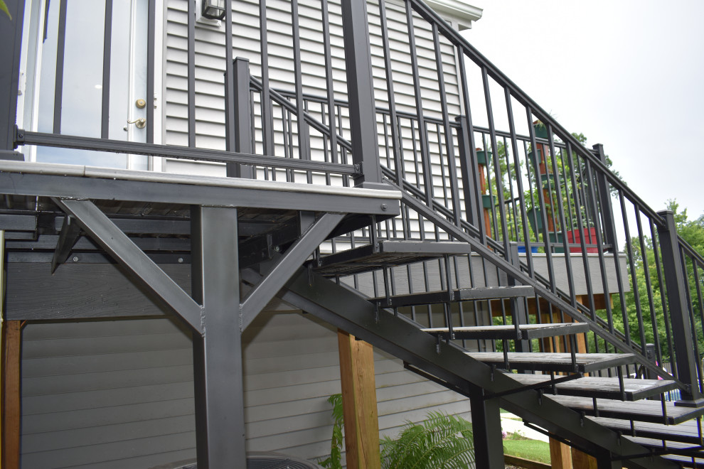 This is an example of a large classic metal l-shaped metal railing staircase in Cincinnati with metal risers.