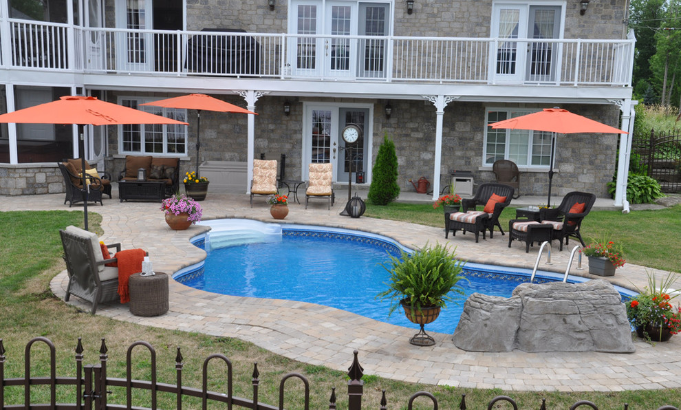 Pool - small transitional backyard brick and kidney-shaped pool idea