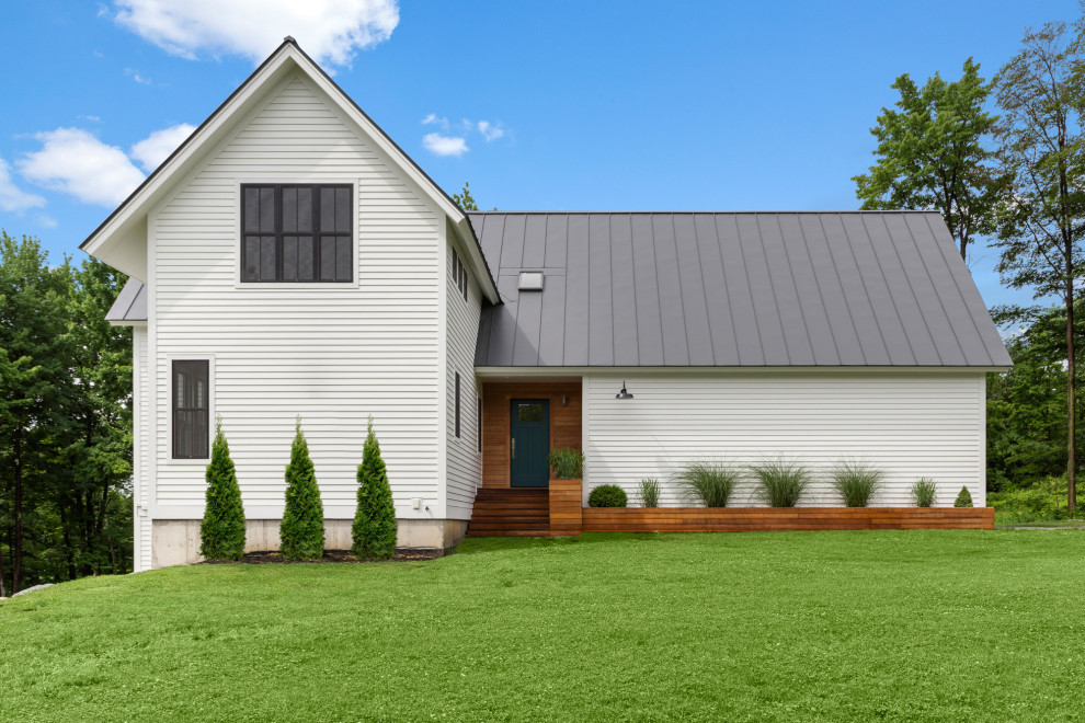 Medium sized and white farmhouse two floor detached house in Burlington with wood cladding, a pitched roof, a metal roof, a grey roof and shiplap cladding.