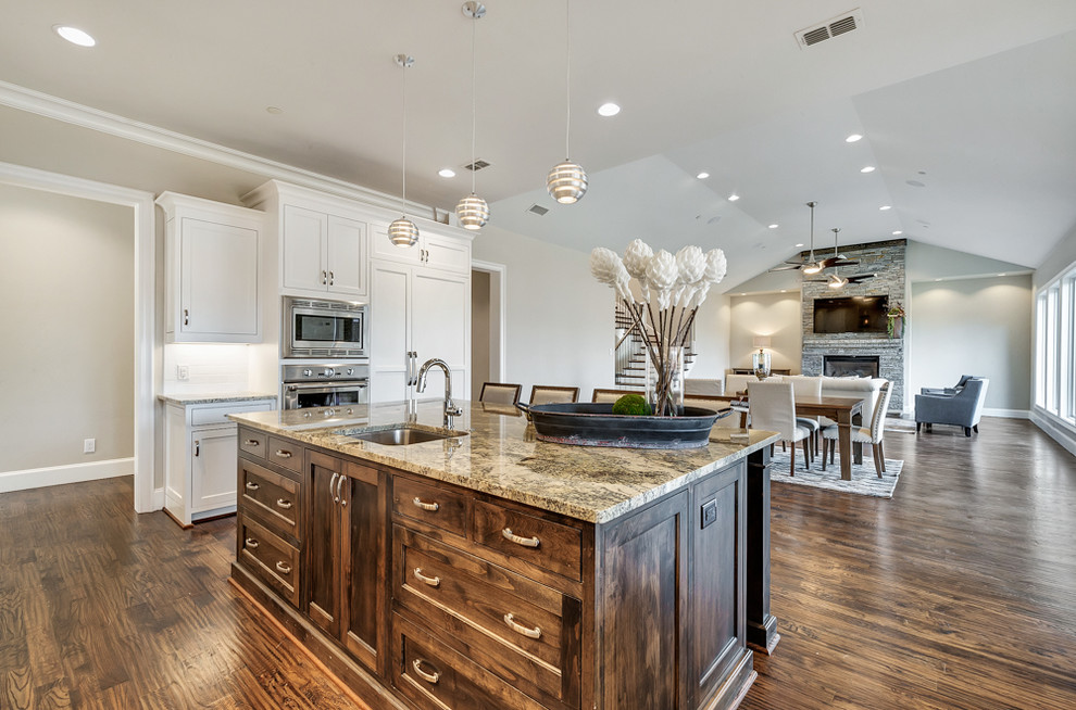Design ideas for a large transitional eat-in kitchen in Dallas with an undermount sink, beaded inset cabinets, medium wood cabinets, granite benchtops, white splashback, ceramic splashback, stainless steel appliances, medium hardwood floors and with island.