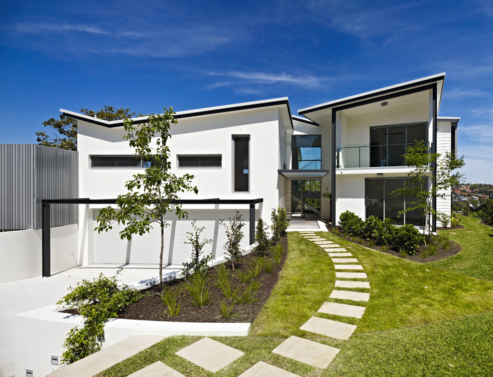 Large contemporary two-storey white exterior in Sydney with a shed roof.