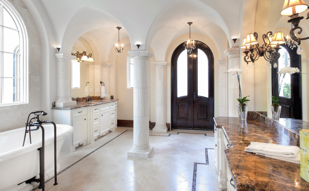Design ideas for a mediterranean bathroom in Houston with an undermount sink, white cabinets and a freestanding tub.