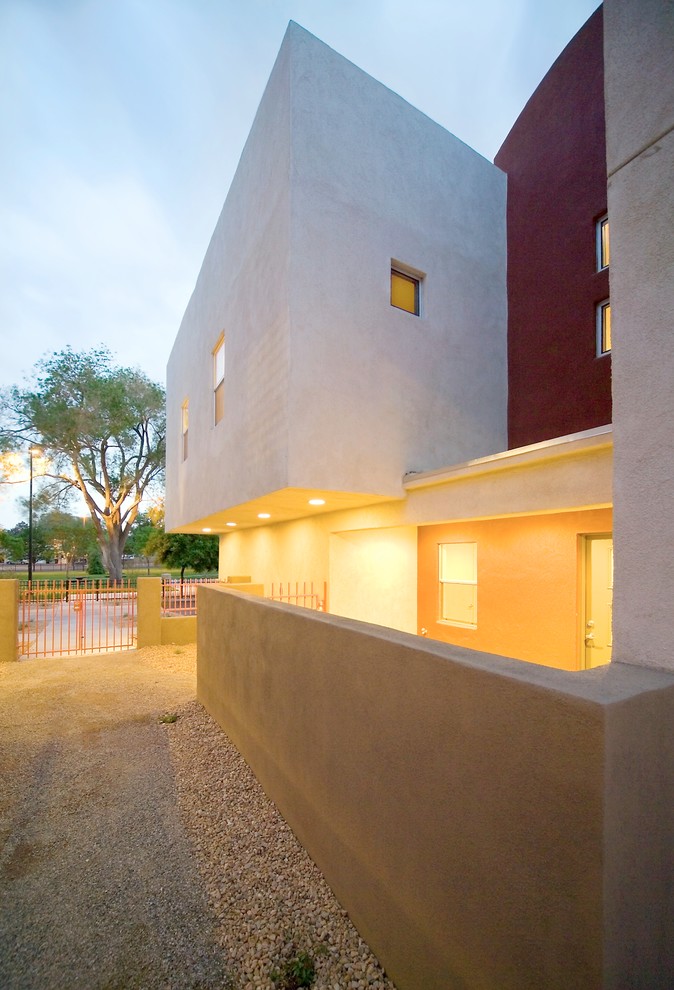 Photo of a small contemporary two-storey stucco exterior in Albuquerque.