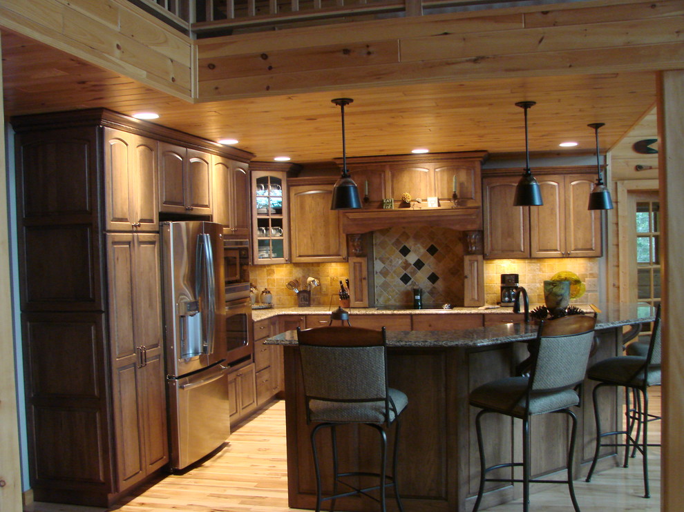 Inspiration for a small rustic l-shaped light wood floor enclosed kitchen remodel with raised-panel cabinets, beige cabinets, granite countertops, porcelain backsplash, stainless steel appliances and an island
