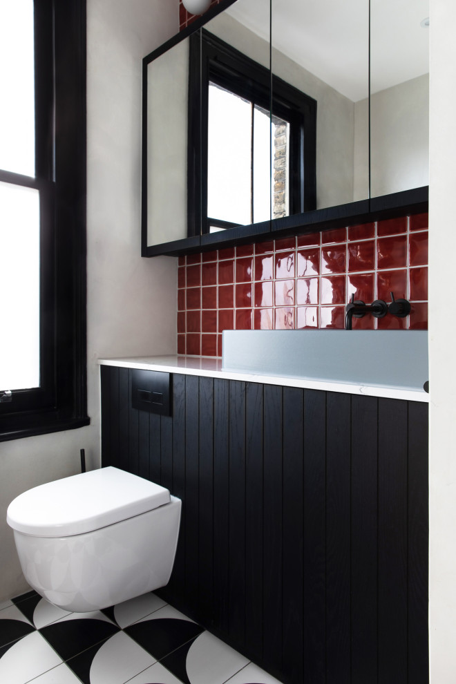 Bathroom - small contemporary kids' red tile and subway tile porcelain tile, multicolored floor and single-sink bathroom idea in London with glass-front cabinets, black cabinets, a one-piece toilet, gray walls, a trough sink, quartzite countertops, white countertops and a built-in vanity