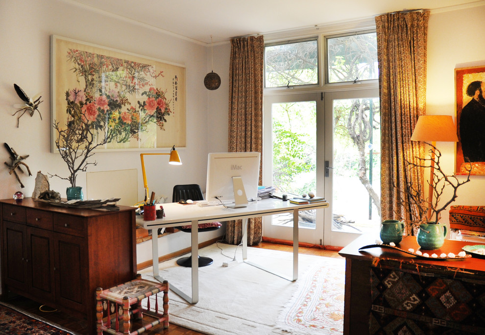 Eclectic home office in Sydney with grey walls and a freestanding desk.