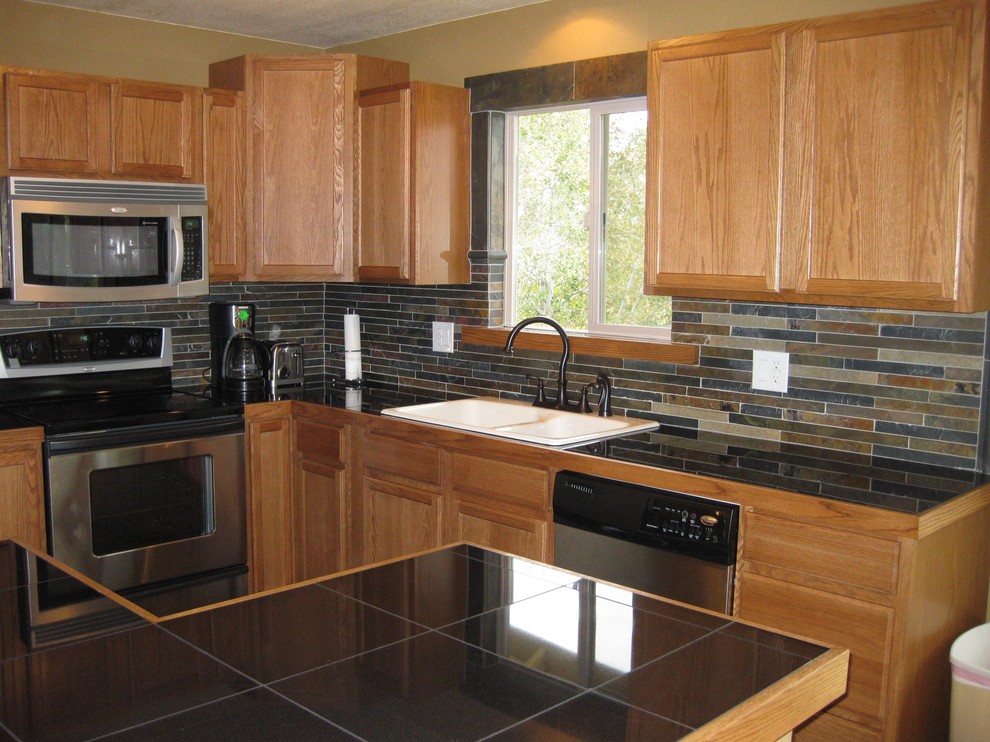 Open concept kitchen - large rustic l-shaped open concept kitchen idea with a double-bowl sink, raised-panel cabinets, medium tone wood cabinets, granite countertops, multicolored backsplash, matchstick tile backsplash, stainless steel appliances and an island