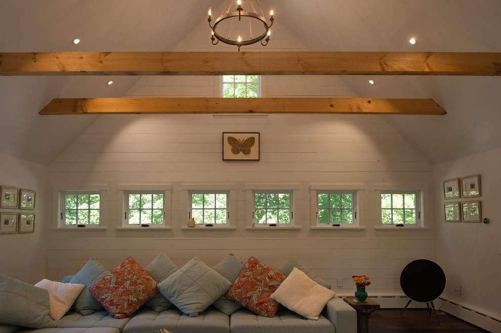 This is an example of a large country open concept family room in Boston with white walls.