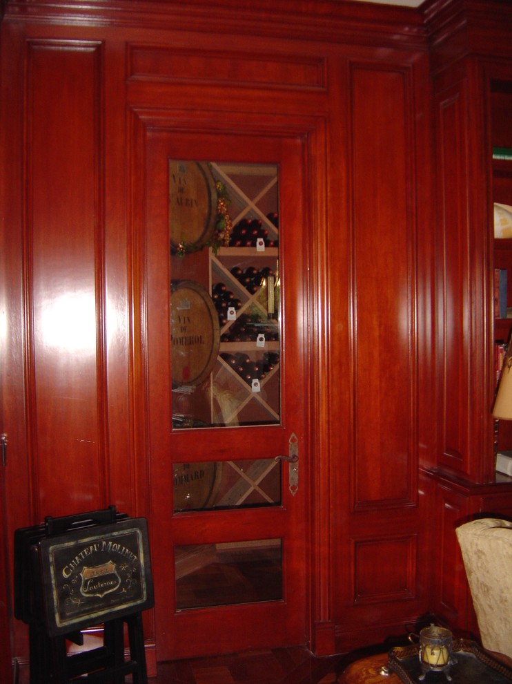 Photo of a mid-sized traditional wine cellar in Orange County with ceramic floors and diamond bins.