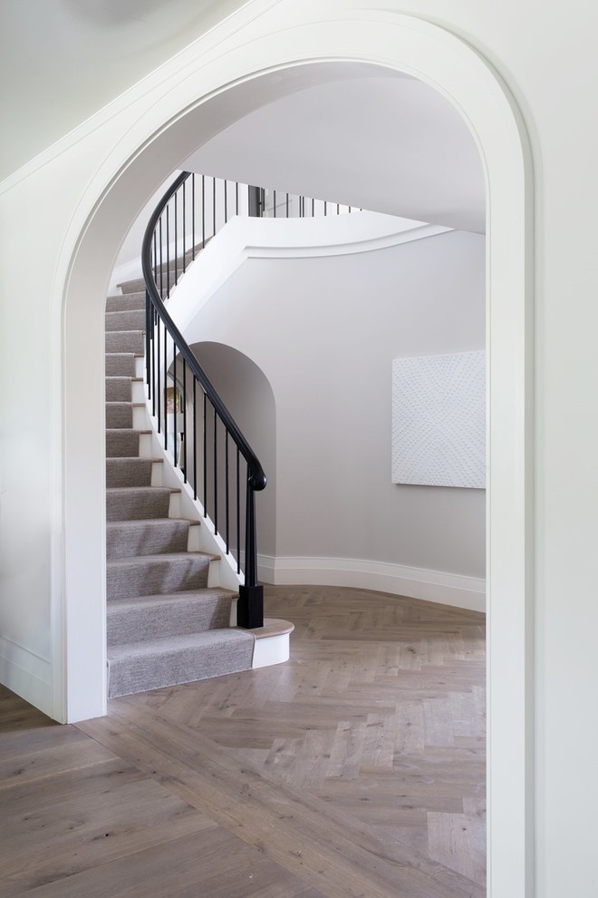 Large transitional medium tone wood floor and brown floor hallway photo with gray walls