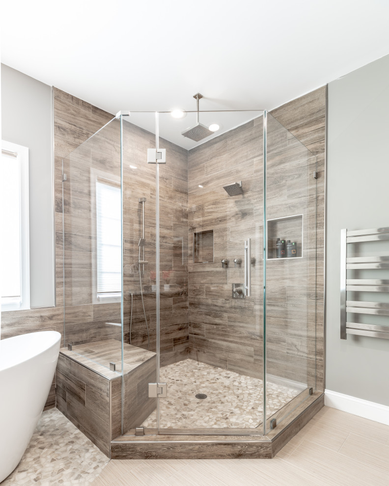 Inspiration for a large contemporary master bathroom in DC Metro with black cabinets, a freestanding tub, a corner shower, a two-piece toilet, beige tile, beige walls, ceramic floors, granite benchtops, beige floor, a hinged shower door and beige benchtops.