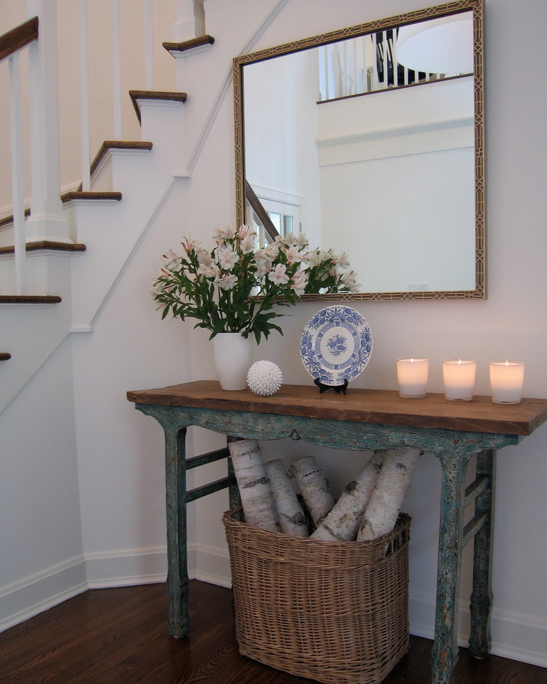 Photo of a mid-sized beach style foyer in New York with white walls and dark hardwood floors.
