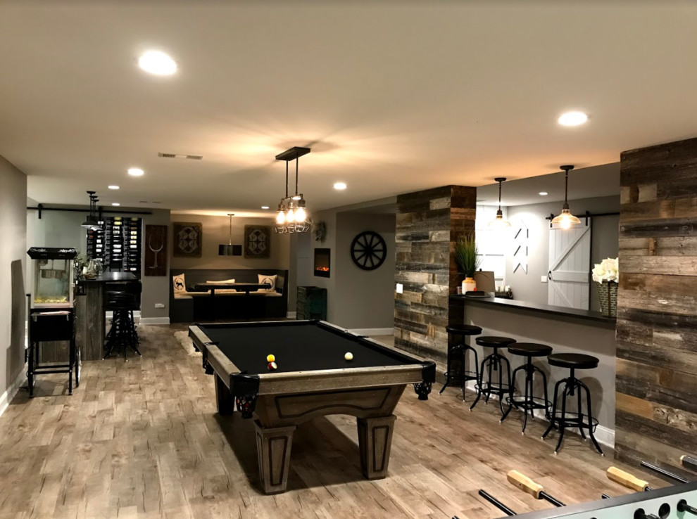 Design ideas for a large transitional fully buried basement in Other with beige walls, light hardwood floors, no fireplace, beige floor and a game room.
